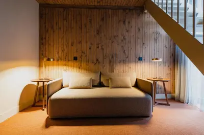 a bedroom with a bed and a wooden wall at Hotel van de Vijsel in Amsterdam