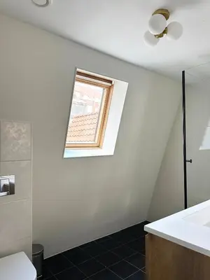 a bathroom with a sink and a window at Rembrandtplein Apartments in Amsterdam