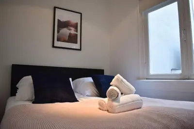 a bedroom with a bed with two towels on it at Rembrandtplein Apartments in Amsterdam