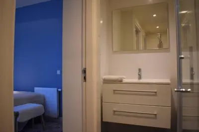 a bathroom with a sink and a mirror at Rembrandtplein Apartments in Amsterdam