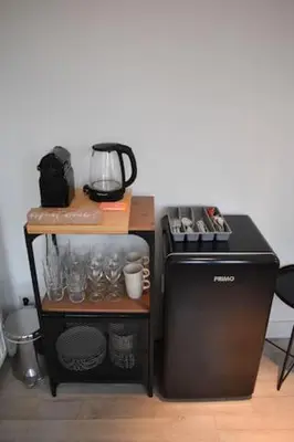 a table with a coffee maker and a blender at Rembrandtplein Apartments in Amsterdam