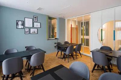 a restaurant with tables and chairs in a room at Quentin Zoo Hotel in Amsterdam