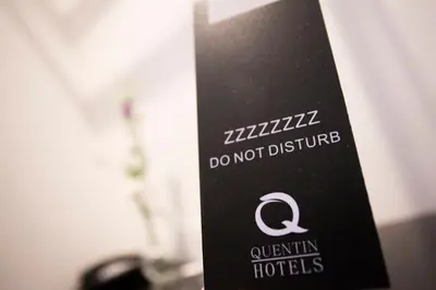 a sign that says do not disturb in a hotel at Quentin Zoo Hotel in Amsterdam