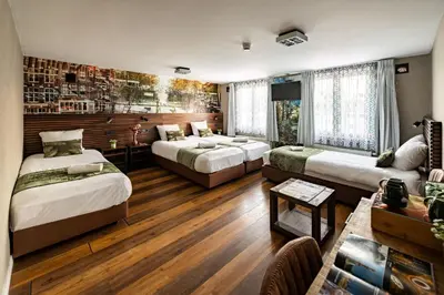 a room with three beds and a table in a room at Historic Centre Hotel in Amsterdam