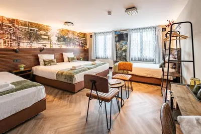 a hotel room with two beds and a ladder at Historic Centre Hotel in Amsterdam