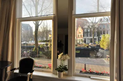 a window with a view of a city at The Posthoorn Amsterdam in Amsterdam