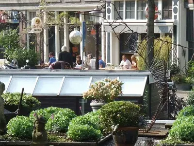 a group of people sitting at a restaurant at The Posthoorn Amsterdam in Amsterdam
