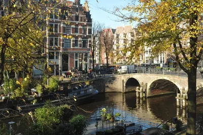 a bridge over a river in a city with buildings at The Posthoorn Amsterdam in Amsterdam