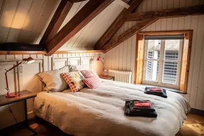 a bedroom with a large bed in a attic at Boerenhofstede de Overhorn in Weesp