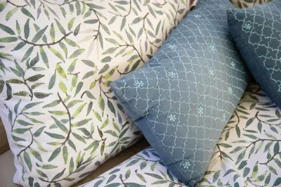 a pile of pillows sitting on top of a bed at Boerenhofstede de Overhorn in Weesp