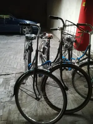 two bikes parked next to each other on a street at The Water Studio in Amsterdam