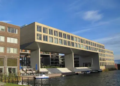 a building next to a body of water at The Water Studio in Amsterdam