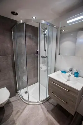 a bathroom with a shower and a sink and a toilet at Central & Quiet Canal Apartment in Amsterdam