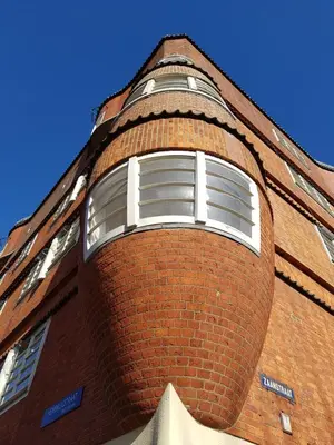 a brick building with a clock tower on it at Central & Quiet Canal Apartment in Amsterdam