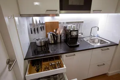 a kitchen counter with a stove and a sink at Central & Quiet Canal Apartment in Amsterdam