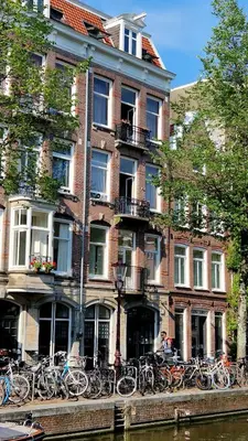 a building with a bunch of bikes parked in front of it at Canal House The Tannery Amsterdam in Amsterdam