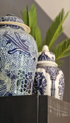 two blue and white vases sitting on a table at Canal House The Tannery Amsterdam in Amsterdam