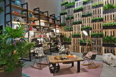 a room with a table and chairs and plants at Moxy Amsterdam Houthavens in Amsterdam