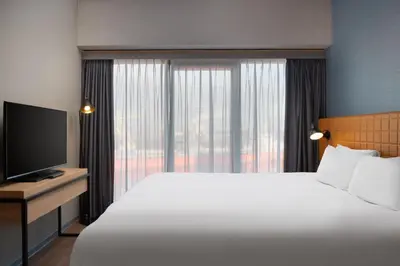 a hotel room with a large bed and a television at Residence Inn by Marriott Amsterdam Houthavens in Amsterdam