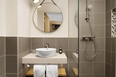 a bathroom with a sink and a shower at Residence Inn by Marriott Amsterdam Houthavens in Amsterdam