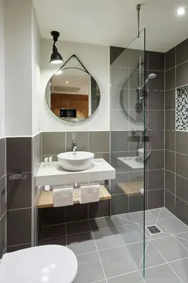 a bathroom with a sink and a glass shower at Residence Inn by Marriott Amsterdam Houthavens in Amsterdam