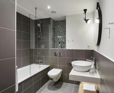 a bathroom with a sink and a toilet and a shower at Residence Inn by Marriott Amsterdam Houthavens in Amsterdam