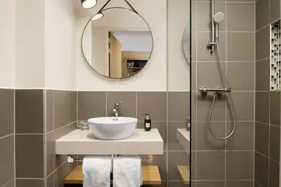 a bathroom with a sink and a shower at Residence Inn by Marriott Amsterdam Houthavens in Amsterdam