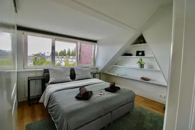 a bedroom with a bed with two teddy bears on it at Beautiful penthouse near Rai and centre in Amsterdam