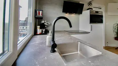 a kitchen with a sink and a counter top at Beautiful penthouse near Rai and centre in Amsterdam
