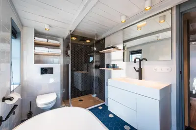 a bathroom with a toilet and a sink and a shower at Numa Amsterdam The Crane in Amsterdam