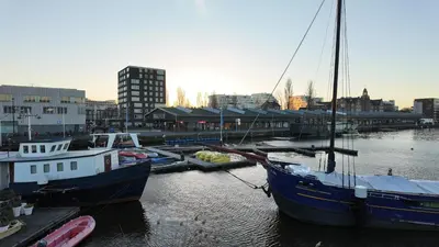 two boats docked at a dock in a harbor at Stylish Private Studio Close to City in Amsterdam