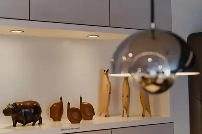 a shelf with vases and sculptures on a wall at Hotel JL No76 in Amsterdam