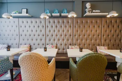 a dining room with tables and chairs and a wall at Hotel JL No76 in Amsterdam