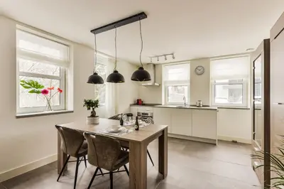 a kitchen and dining room with a table and chairs at Luxury Family Residence Schinkeldijkje in Aalsmeer