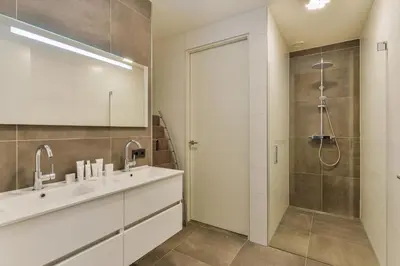 a bathroom with a sink and a shower at Luxury Family Residence Schinkeldijkje in Aalsmeer