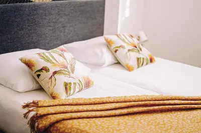 a bed with two pillows and a blanket on it at Boutique Lodge Zandvoort in Zandvoort