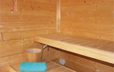 a wooden sauna with a trash can in it at Penhuis in Winkel