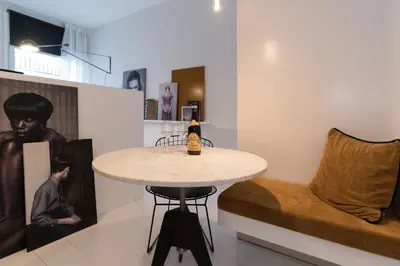 a dining room with a table and a chair at Canal Suite City Centre in Amsterdam