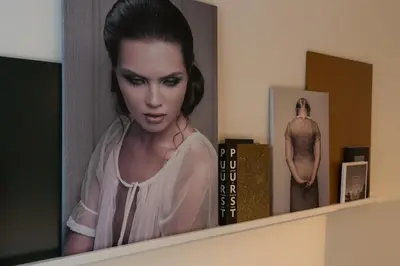 a picture of a woman on a shelf with books at Canal Suite City Centre in Amsterdam