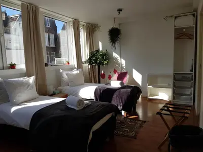 a room with two beds in a room at City Break Amsterdam in Amsterdam