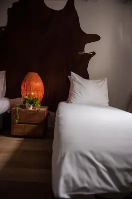 a bedroom with a bed and a lamp on a night stand at City Break Amsterdam in Amsterdam