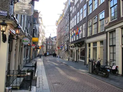 a cobblestone street in a city with buildings at City Break Amsterdam in Amsterdam