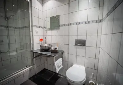 a bathroom with a toilet and a sink and a shower at City Break Amsterdam in Amsterdam