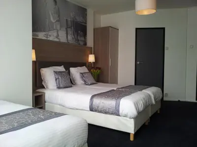 a hotel room with two beds in a room at The Concert Hotel in Amsterdam