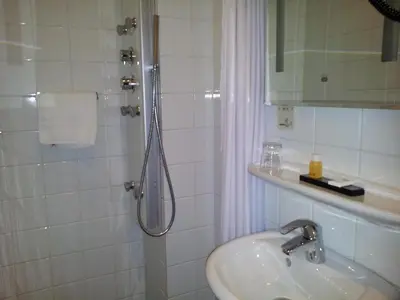 a bathroom with a shower and a sink at The Concert Hotel in Amsterdam