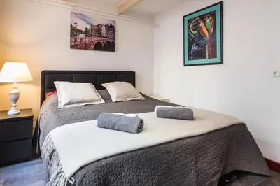 a bedroom with a bed with two pillows on it at City Heart Station Amsterdam in Amsterdam