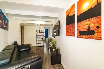 a living room with a leather couch in a room at City Heart Station Amsterdam in Amsterdam
