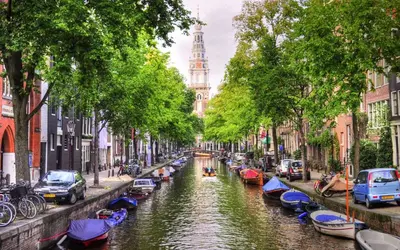 a canal in a city with boats in it at City Heart Station Amsterdam in Amsterdam