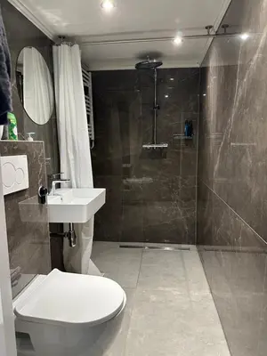 a bathroom with a toilet and a shower and a sink at City Heart Station Amsterdam in Amsterdam