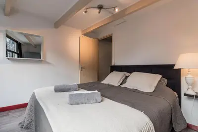 a bedroom with a large bed with two pillows on it at City Heart Station Amsterdam in Amsterdam